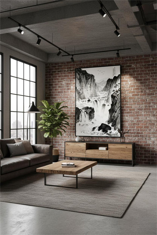 The River Carves Through Stone ink painting in a black frame above a wooden sideboard on a brick wall in a living room
